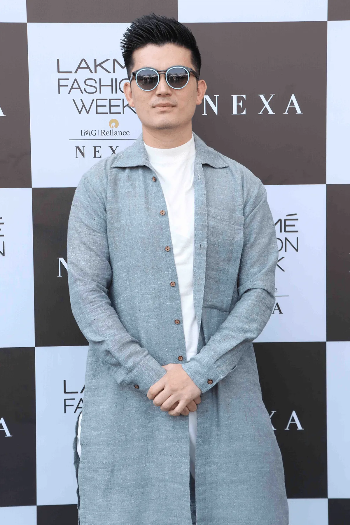 Meiyang Chang In Blue long shirt with white polo neck and white trousers